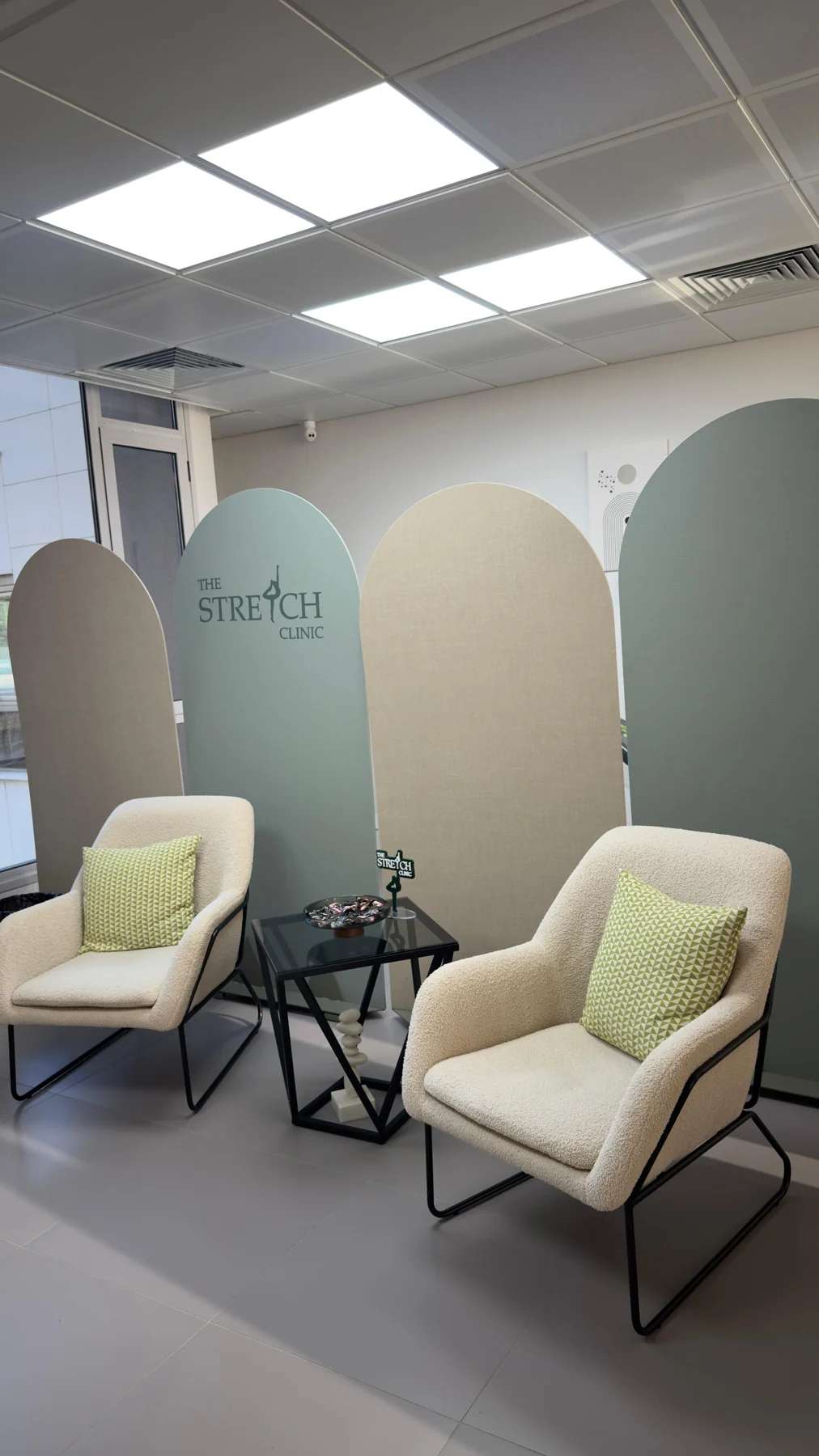 The clinic’s lounge with mint green partitions and cream armchairs